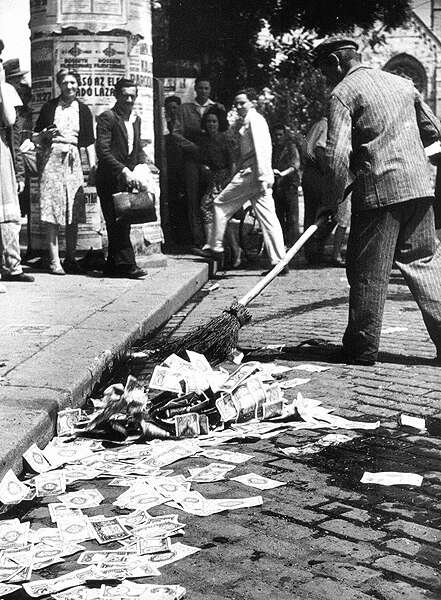 Sweeping up Hungarian banknotes after the Hungarian pengö was replaced in 1946.