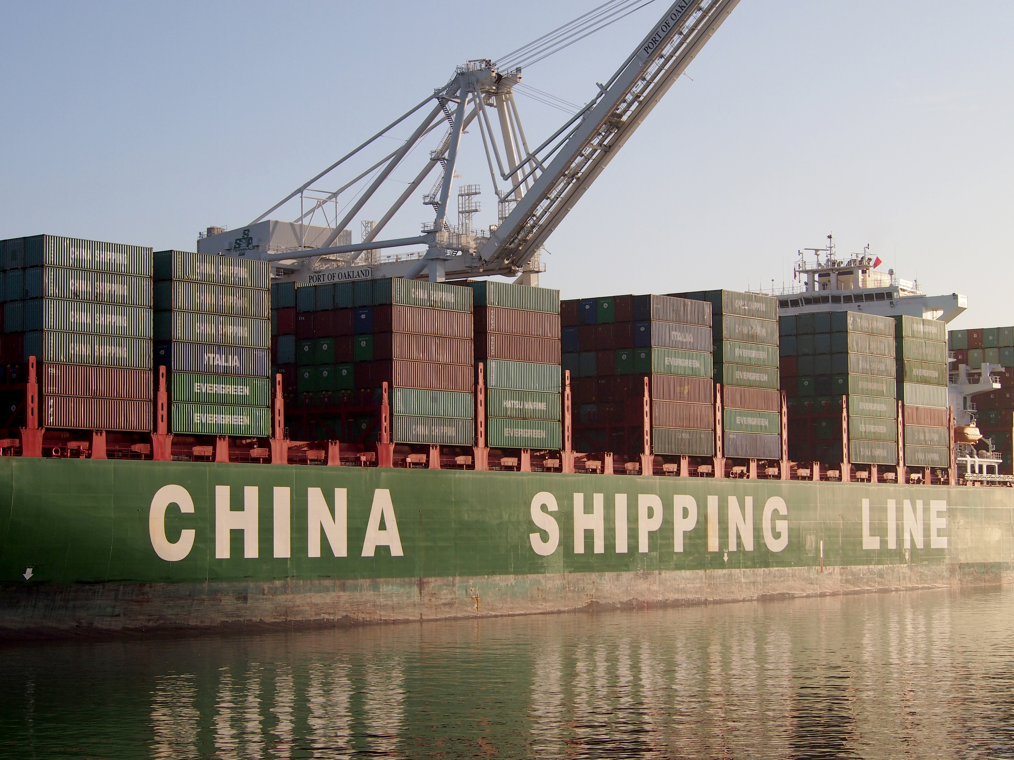 China Shipping Line container ship being unloaded in Oakland, California harbor.